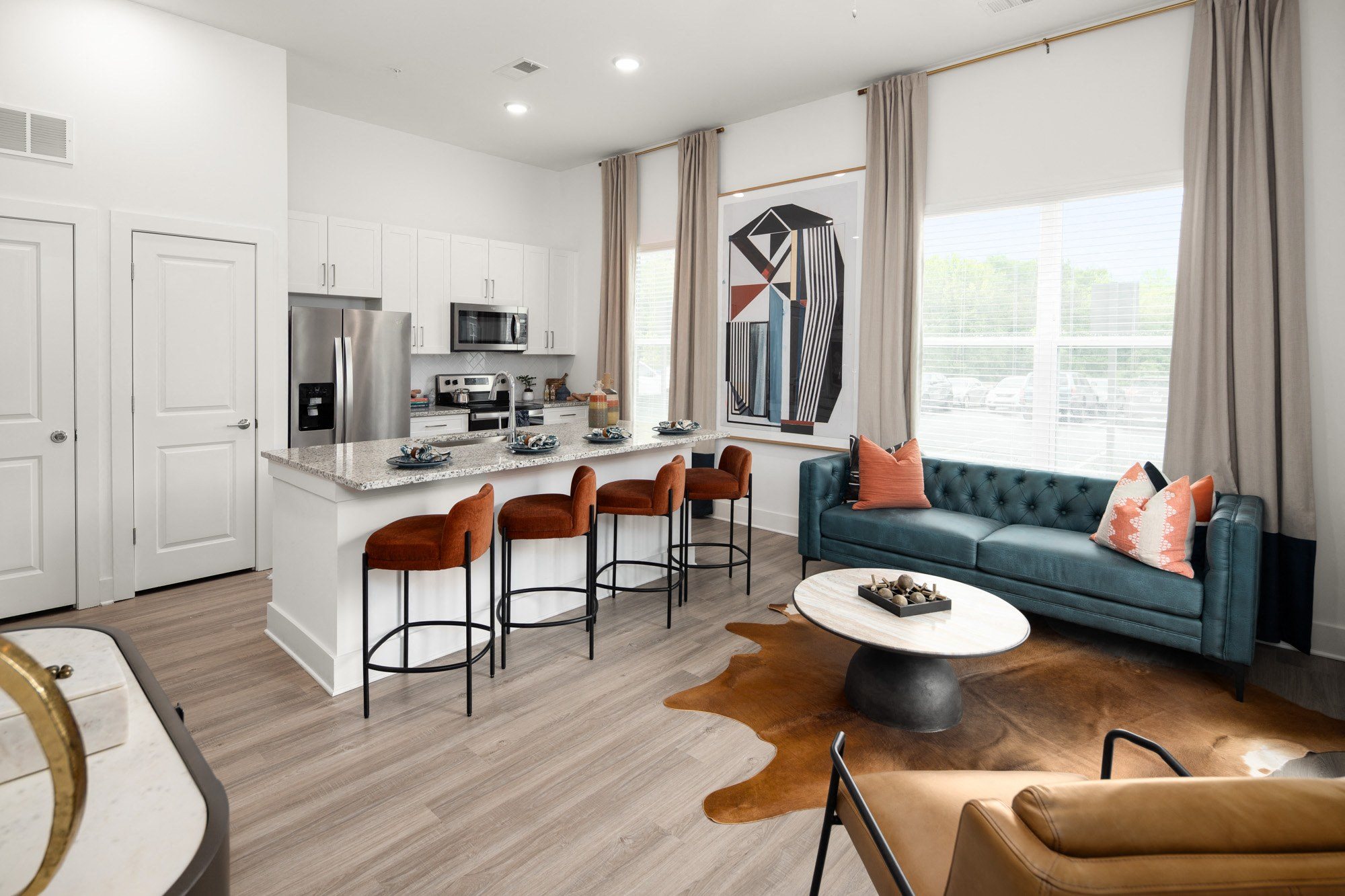 a living area with a kitchen and a couch and a table